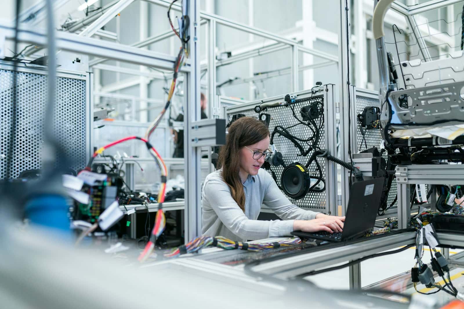Worker on an industrial manufacturing floor with an active production line